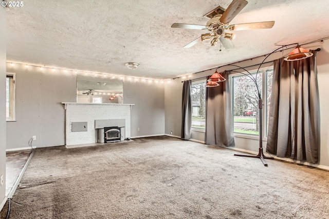 unfurnished living room with carpet floors, a wood stove, a textured ceiling, and ceiling fan