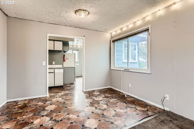 empty room featuring a textured ceiling