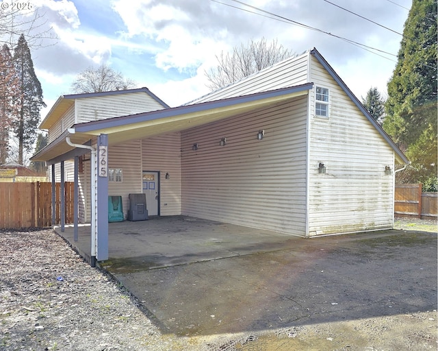 exterior space with a carport and fence