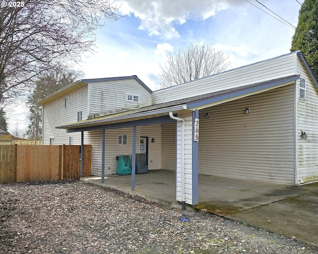 back of property featuring a patio and fence