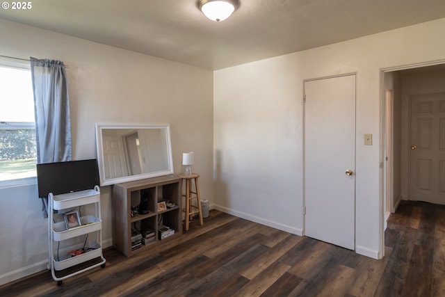 interior space with dark wood-style floors and baseboards