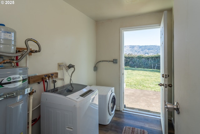 washroom with laundry area, dark wood-style floors, and independent washer and dryer