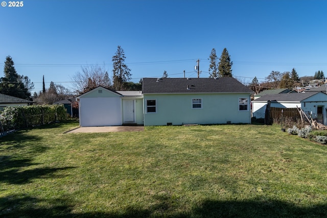 back of property featuring a patio area, fence, and a lawn