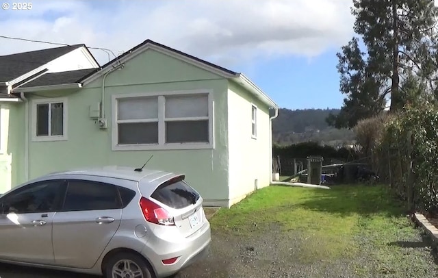 view of property exterior with a yard and stucco siding