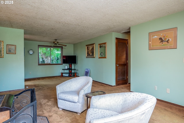 1363 SE 135th Ave, Portland, OR 97233 - living room featuring a ceiling fan, carpet flooring, a textured ceiling, and baseboards