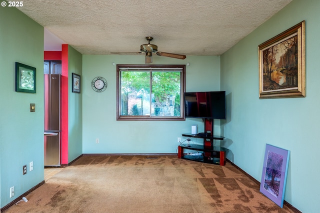 1363 SE 135th Ave, Portland, OR 97233 - living room with carpet floors, a ceiling fan, a textured ceiling, and baseboards