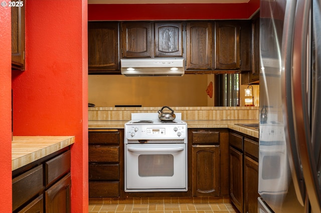 1363 SE 135th Ave, Portland, OR 97233 - kitchen featuring white electric range oven, freestanding refrigerator, under cabinet range hood, and light countertops