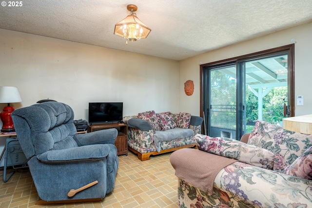 1363 SE 135th Ave, Portland, OR 97233 - living area with brick patterned floors, a textured ceiling, and a chandelier