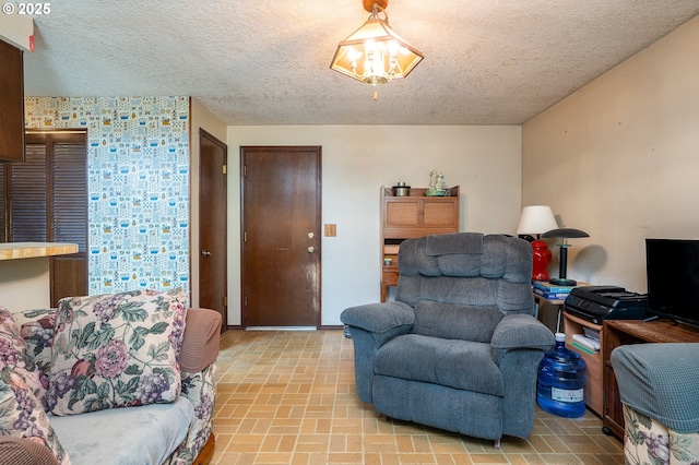 1363 SE 135th Ave, Portland, OR 97233 - living room with brick patterned flooring, a textured ceiling, wallpapered walls, and baseboards