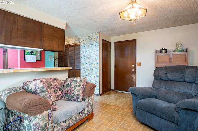1363 SE 135th Ave, Portland, OR 97233 - living room with brick patterned flooring, a textured ceiling, a chandelier, and baseboards