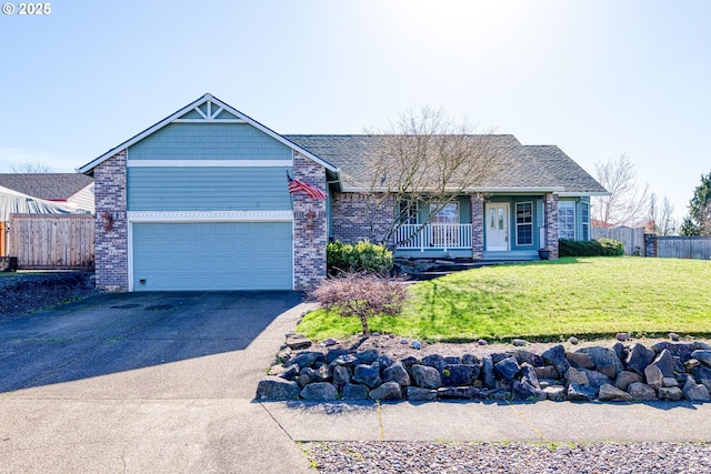 view of front of house with driveway, fence, a front yard, a porch, and brick siding