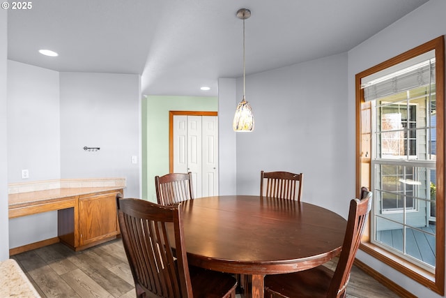 dining room with recessed lighting, baseboards, and wood finished floors