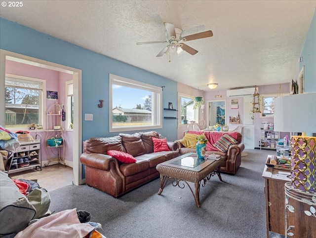 carpeted living area with a textured ceiling, ceiling fan, and a wall mounted air conditioner