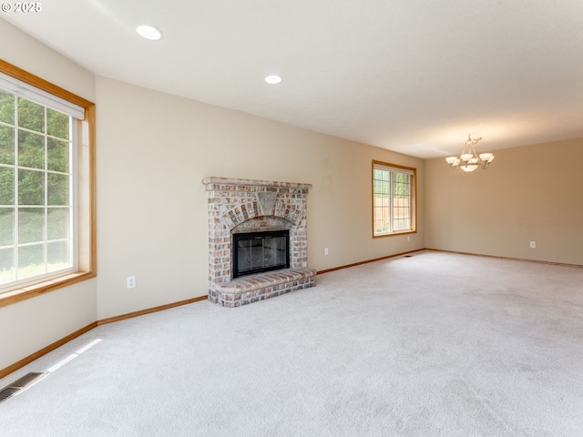 651 SW Westview Dr, Mcminnville, OR 97128 - unfurnished living room with a chandelier, carpet floors, a brick fireplace, and recessed lighting