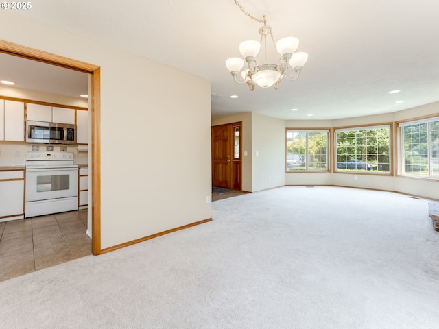 651 SW Westview Dr, Mcminnville, OR 97128 - unfurnished living room featuring light colored carpet, a chandelier, recessed lighting, and healthy amount of natural light