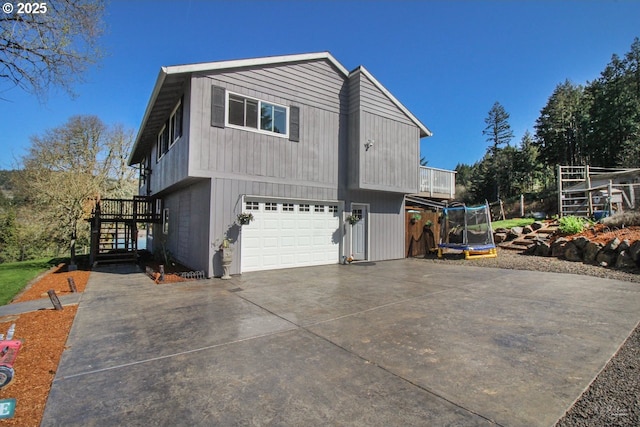38185 SW Laurelwood Rd, Gaston, OR 97119 - view of property exterior with a trampoline, driveway, stairway, and a garage
