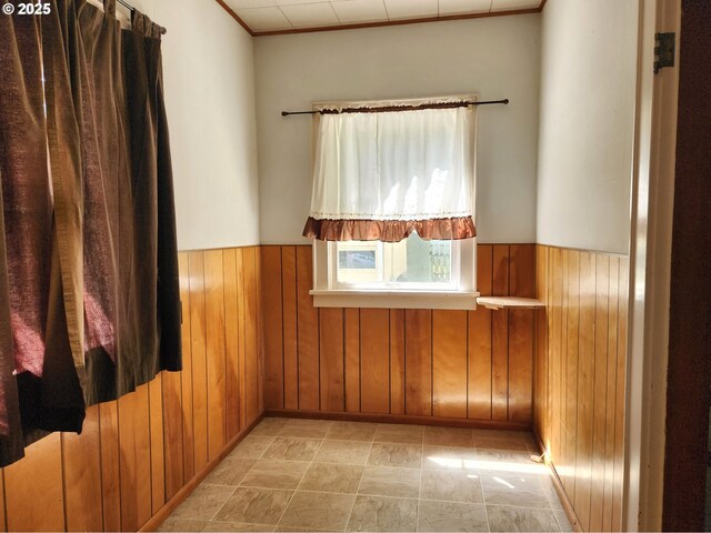 1914 1st St, La Grande, OR 97850 - unfurnished room featuring wooden walls, a wainscoted wall, and ornamental molding