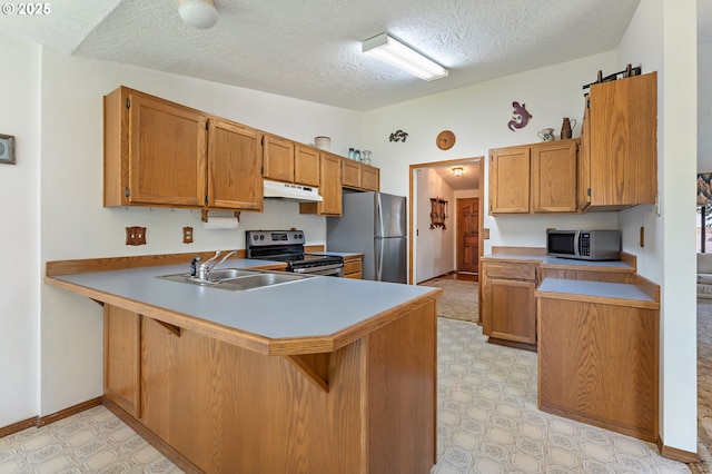 1430 NW 19th St, Gresham, OR 97030 - kitchen featuring stainless steel appliances, under cabinet range hood, a peninsula, light flooring, and a textured ceiling