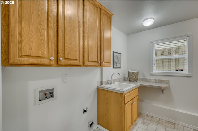 laundry room with cabinets, hookup for an electric dryer, hookup for a washing machine, and sink