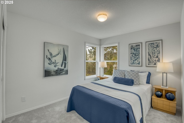 carpeted bedroom featuring a textured ceiling