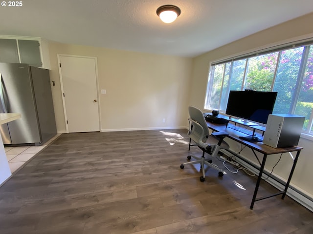 office area with baseboards and light wood-style flooring