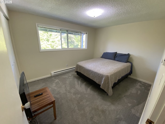 carpeted bedroom with baseboard heating, a textured ceiling, and baseboards