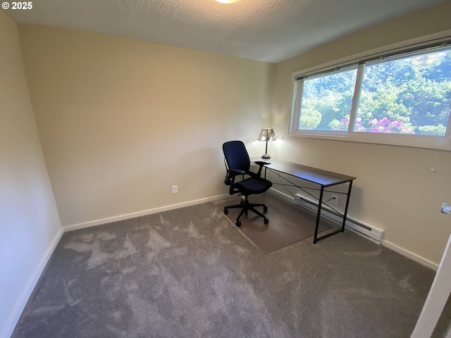 carpeted office space with baseboard heating, a textured ceiling, and baseboards