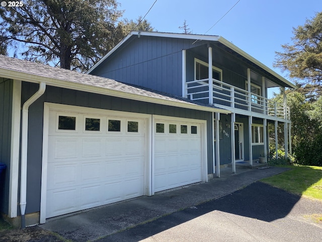 view of home's exterior featuring a balcony, asphalt driveway, a shingled roof, and a garage
