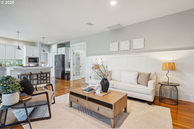 1365 NW 96th Ave, Portland, OR 97229 - living area featuring light wood-style floors, recessed lighting, and a wainscoted wall