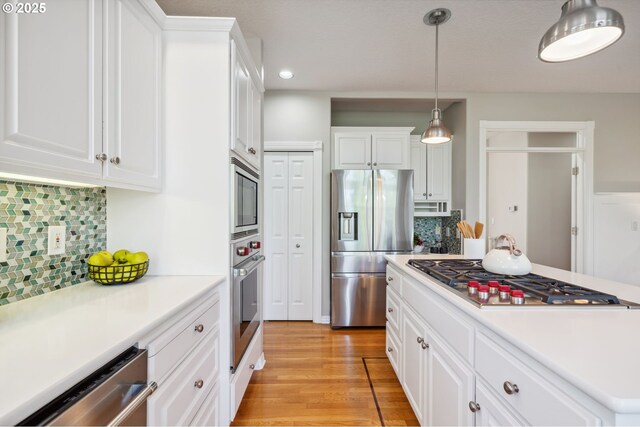 1365 NW 96th Ave, Portland, OR 97229 - kitchen featuring stainless steel appliances, white cabinetry, light countertops, light wood-style flooring, and recessed lighting