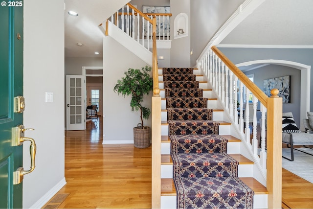 1365 NW 96th Ave, Portland, OR 97229 - foyer entrance featuring stairs, light wood-type flooring, baseboards, arched walkways, and recessed lighting