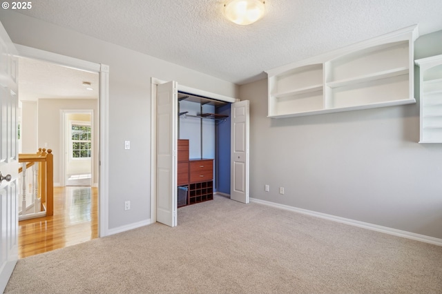1365 NW 96th Ave, Portland, OR 97229 - unfurnished bedroom featuring carpet flooring, a textured ceiling, a closet, and baseboards
