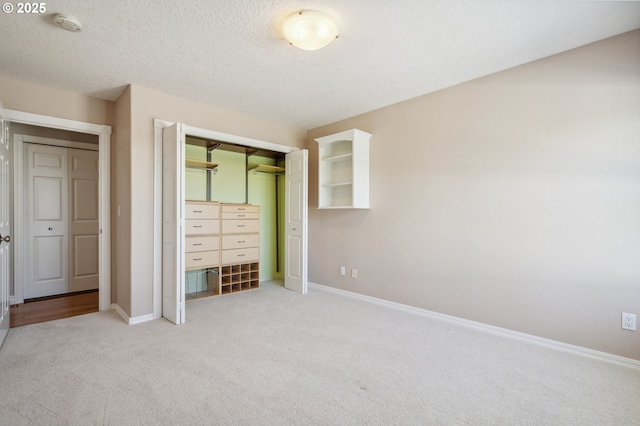 1365 NW 96th Ave, Portland, OR 97229 - unfurnished bedroom featuring carpet flooring, a closet, baseboards, and a textured ceiling