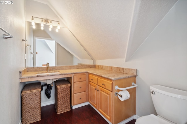 1365 NW 96th Ave, Portland, OR 97229 - half bathroom featuring a sink, vaulted ceiling, toilet, wood finished floors, and a textured ceiling