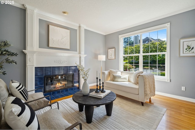 1365 NW 96th Ave, Portland, OR 97229 - living room with ornamental molding, baseboards, wood finished floors, and a tiled fireplace