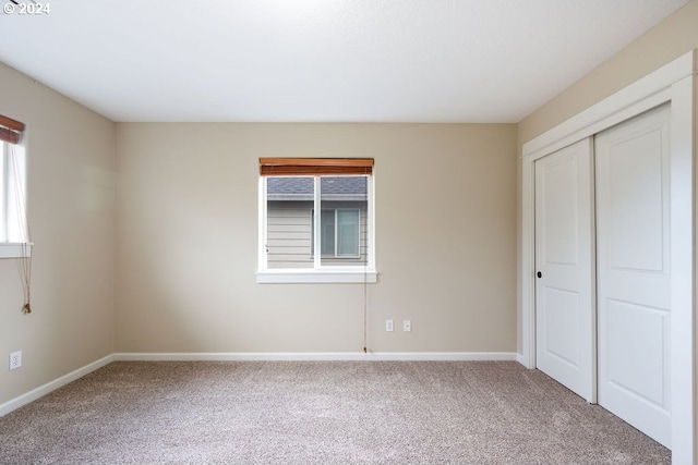 unfurnished bedroom featuring carpet floors and a closet