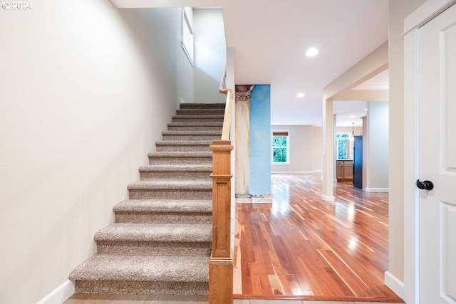 staircase with hardwood / wood-style floors