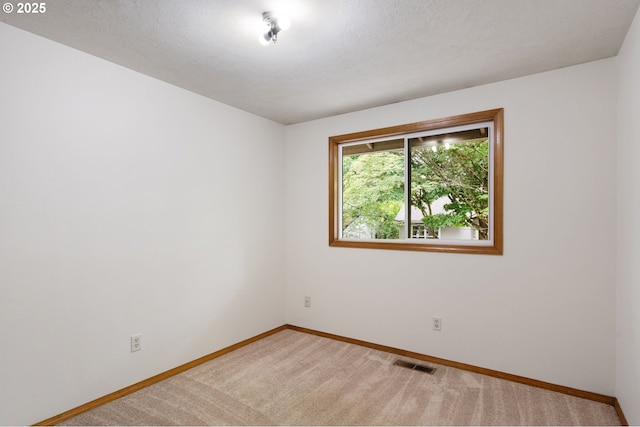 unfurnished room with baseboards and carpet floors