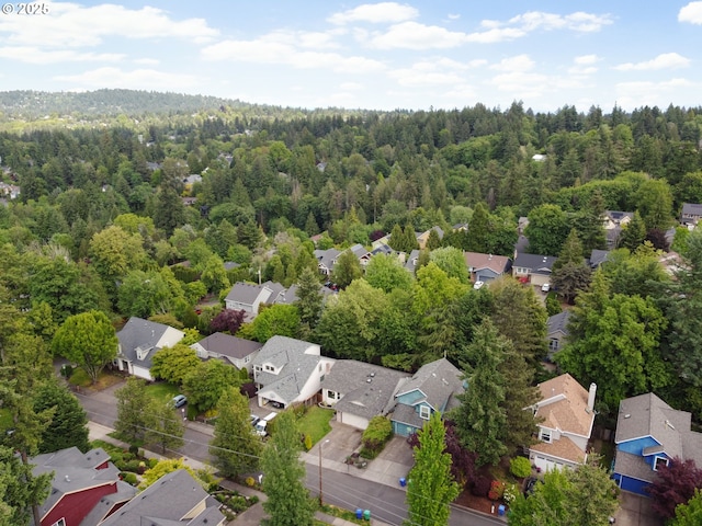 aerial view of residential area featuring a forest