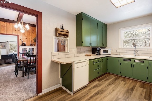 kitchen featuring sink, white appliances, and green cabinetry