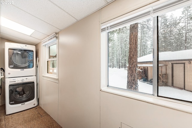 laundry area featuring stacked washer and clothes dryer