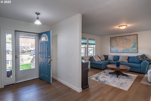 foyer entrance featuring baseboards and wood finished floors