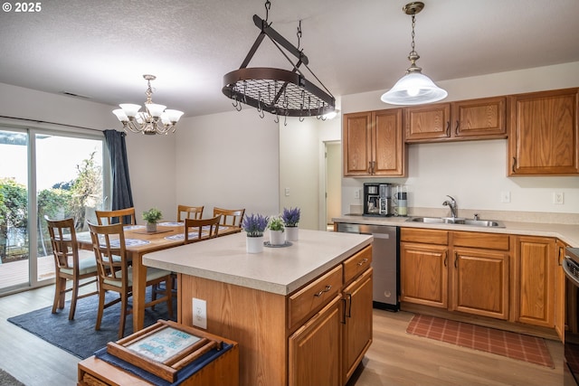 kitchen with dishwasher, light countertops, a notable chandelier, and a sink