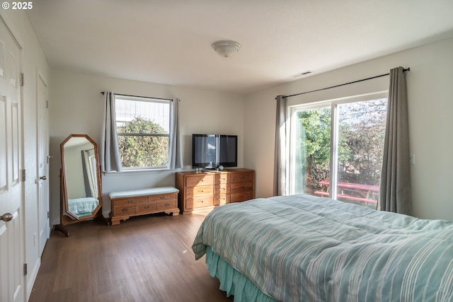 bedroom with visible vents and wood finished floors