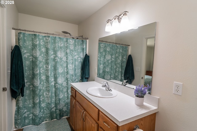 bathroom featuring curtained shower and vanity