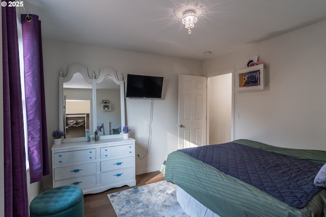 bedroom with baseboards and wood finished floors