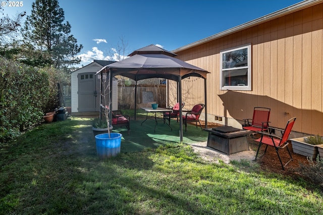 view of yard featuring an outbuilding, a patio, an outdoor fire pit, a gazebo, and a shed