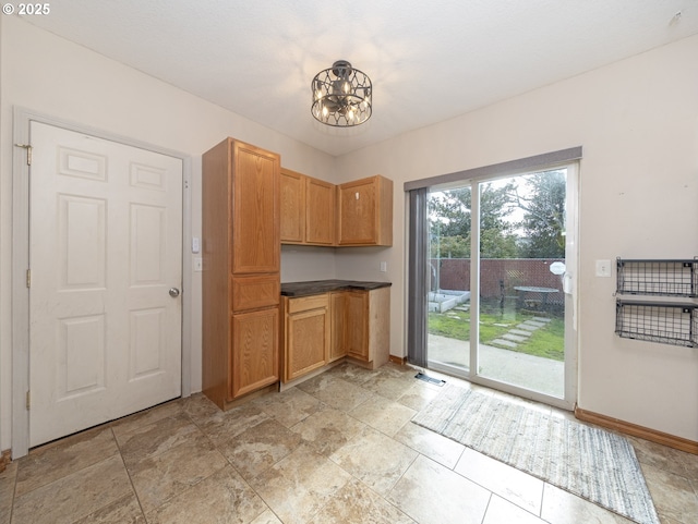1616 Primrose Ln, Forest Grove, OR 97116 - kitchen with a chandelier, baseboards, and dark countertops