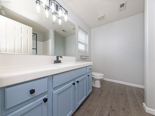 1616 Primrose Ln, Forest Grove, OR 97116 - bathroom with wood finished floors, vanity, toilet, and baseboards