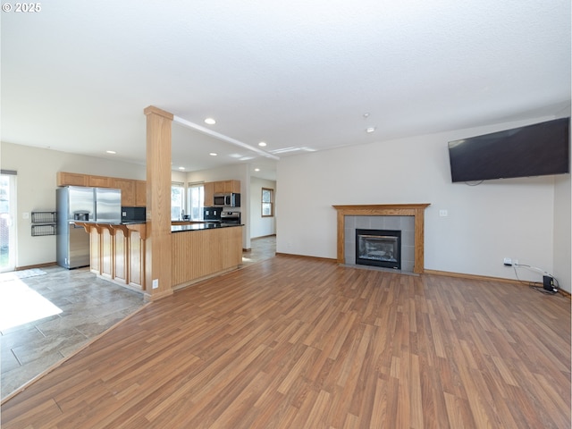 1616 Primrose Ln, Forest Grove, OR 97116 - unfurnished living room with recessed lighting, light wood finished floors, a fireplace, and baseboards